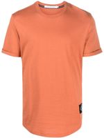 Calvin Klein Jeans t-shirt en coton à patch logo - Orange