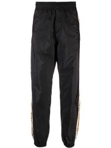 Versace pantalon de jogging en taffetas à rayures - Noir