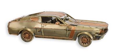 A TIN MODEL OF A MUSCLE CAR
