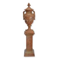 A CAST IRON URN ON A BASE, RUST