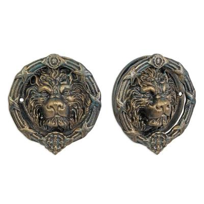 A CAST IRON LION HEAD DOOR KNOCKER