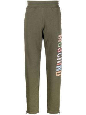 Moschino pantalon de jogging à logo imprimé - Vert