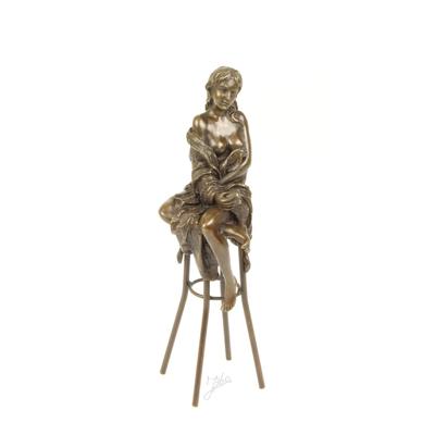 A BRONZE SCULPTURE OF A LADY ON BARCHAIR
