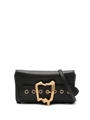 Moschino sac à bandoulière en cuir à logo gravé - Noir