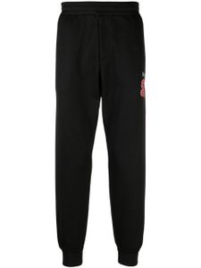 Alexander McQueen pantalon de jogging à logo imprimé - Noir