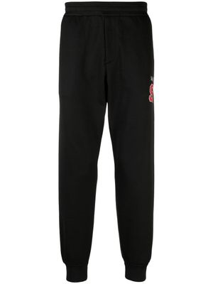 Alexander McQueen pantalon de jogging à logo imprimé - Noir