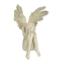 A RESIN FIGURINE OF A RECLINING ANGEL