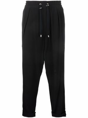 Balmain pantalon de jogging fuselé en crêpe - Noir
