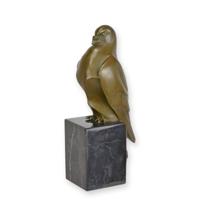 A BRONZE SCULPTURE OF A STING PIGEON ON A MARBLE BASE A BRONZE SCULPTURE OF A STING PIGEON ON A MARBLE BASE