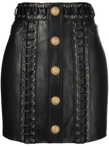 Balmain minijupe en cuir à détails d'œillets - Noir