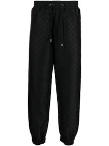 Balmain pantalon de jogging à imprimé monogrammé - Noir