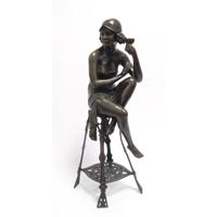 A BRONZE SCULPTURE OF THE CHAMPAGNE LADY