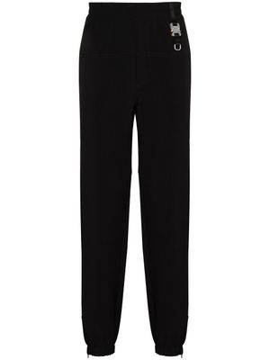 1017 ALYX 9SM pantalon de jogging fuselé à détail de boucle - Noir