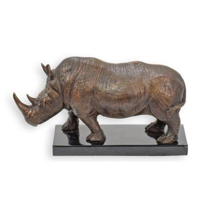 A BRONZE SCULPTURE OF A STANDING RHINO ON A MARBLE BASE
