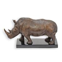 A BRONZE SCULPTURE OF A STANDING RHINO ON A MARBLE BASE