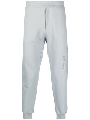 Alexander McQueen pantalon de jogging à logo imprimé - Gris