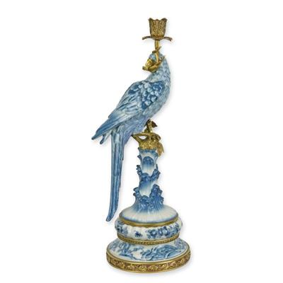 A BRONZE MOUNTED PORCELAIN PARROT CANDLE HOLDER