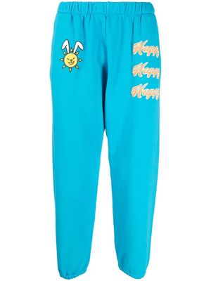 Natasha Zinko pantalon de jogging à imprimé Happy - Bleu