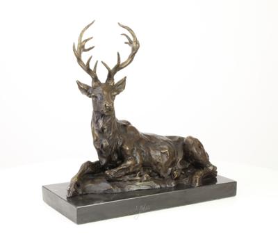A BRONZE SCULPTURE OF A RECLINING DEER