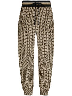 Dolce & Gabbana pantalon en soie à motif monogrammé - Tons neutres
