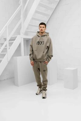 Fear Of God Essentials 1977 Trainingspak Heren Grijs - Maat S - Kleur: Grijs | Soccerfanshop