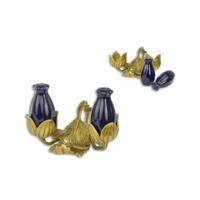 A BRONZE AND PORCELAIN SALT AND PEPPER SHAKER SET