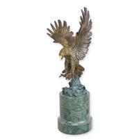 A BRONZE SCULPTURE OF A FLYING EAGLE A BRONZE SCULPTURE OF A FLYING EAGLE