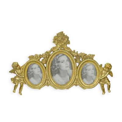 A RESIN TRIPLE PHOTO FRAME FLANKED BY PUTTI