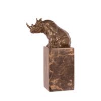 A BRONZE SCULPTURE OF A SITTING RHINOCEROS
