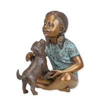 A BRONZE SCULPTURE OF A GIRL SITTING WITH HER DOG