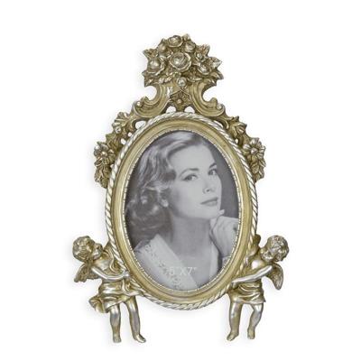 A RESIN PHOTO FRAME FLANKED BY TWO PUTTI