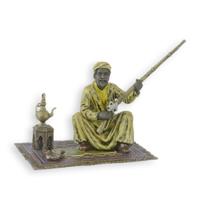 A BRONZE SCULPTURE OF AN ARAB HUNTER ON CARPET A BRONZE SCULPTURE OF AN ARAB HUNTER ON CARPET