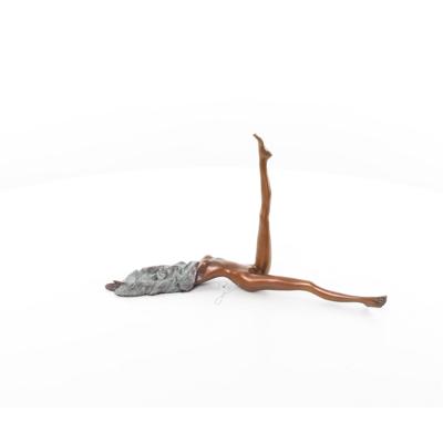 A BRONZE SCULPTURE OF A FEMALE NUDE WITH ONE LEG UP