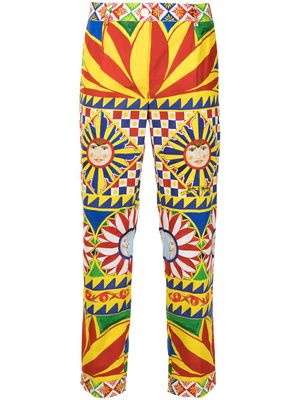 Dolce & Gabbana pantalon à imprimé all-over - Rouge