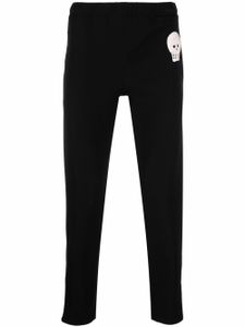 Alexander McQueen pantalon de jogging slim à patch tête de mort - Noir