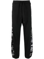 Versace Jeans Couture pantalon de jogging en coton à logo imprimé - Noir Versace Jeans Couture pantalon de jogging en coton à logo imprimé - Noir