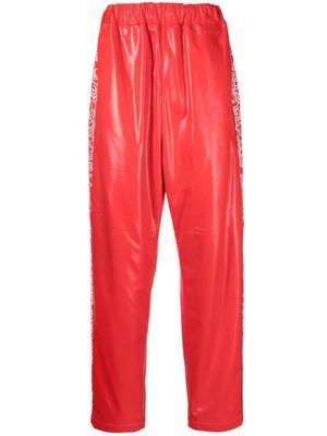 Junya Watanabe MAN pantalon de jogging à imprimé graphique - Rouge