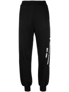 Alexander McQueen pantalon de jogging fuselé à logo imprimé - Noir