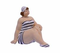 A RESIN FIGURINE OF A WOMAN IN SWIMSUIT