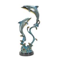 A BRONZE SCULPTURE OF A TWO DOLPHINS ON A WAVE