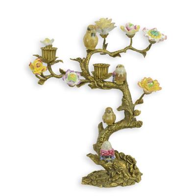 A BRONZE CANDLE STAND MOUNTED WITH PORCELAIN BIRDS