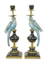 A PAIR OF BRONZE MOUNTED PORCELAIN PARROT CANDLE HOLDERS