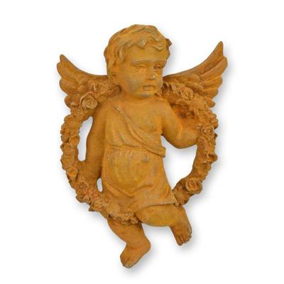 A RUSTY CAST IRON WALL MOUNT PUTTO HOLDING A GUIRLANDE