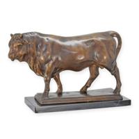 A BRONZE SCULPTURE OF A STANDING BULL