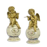 A PAIR OF BRONZE PUTTI ON PORCELAIN BALL