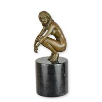 A BRONZE SCULPTURE OF A COWERING NUDE - thumbnail