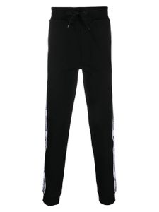 Moschino pantalon de jogging en coton à logo imprimé - Noir