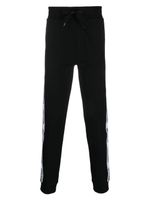 Moschino pantalon de jogging en coton à logo imprimé - Noir