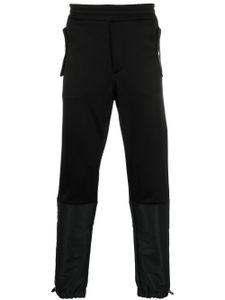 Alexander McQueen pantalon de jogging fuselé à design à empiècements - Noir