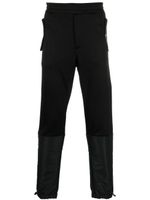 Alexander McQueen pantalon de jogging fuselé à design à empiècements - Noir